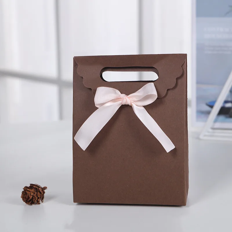 Brown paper gift bag with pink satin bow