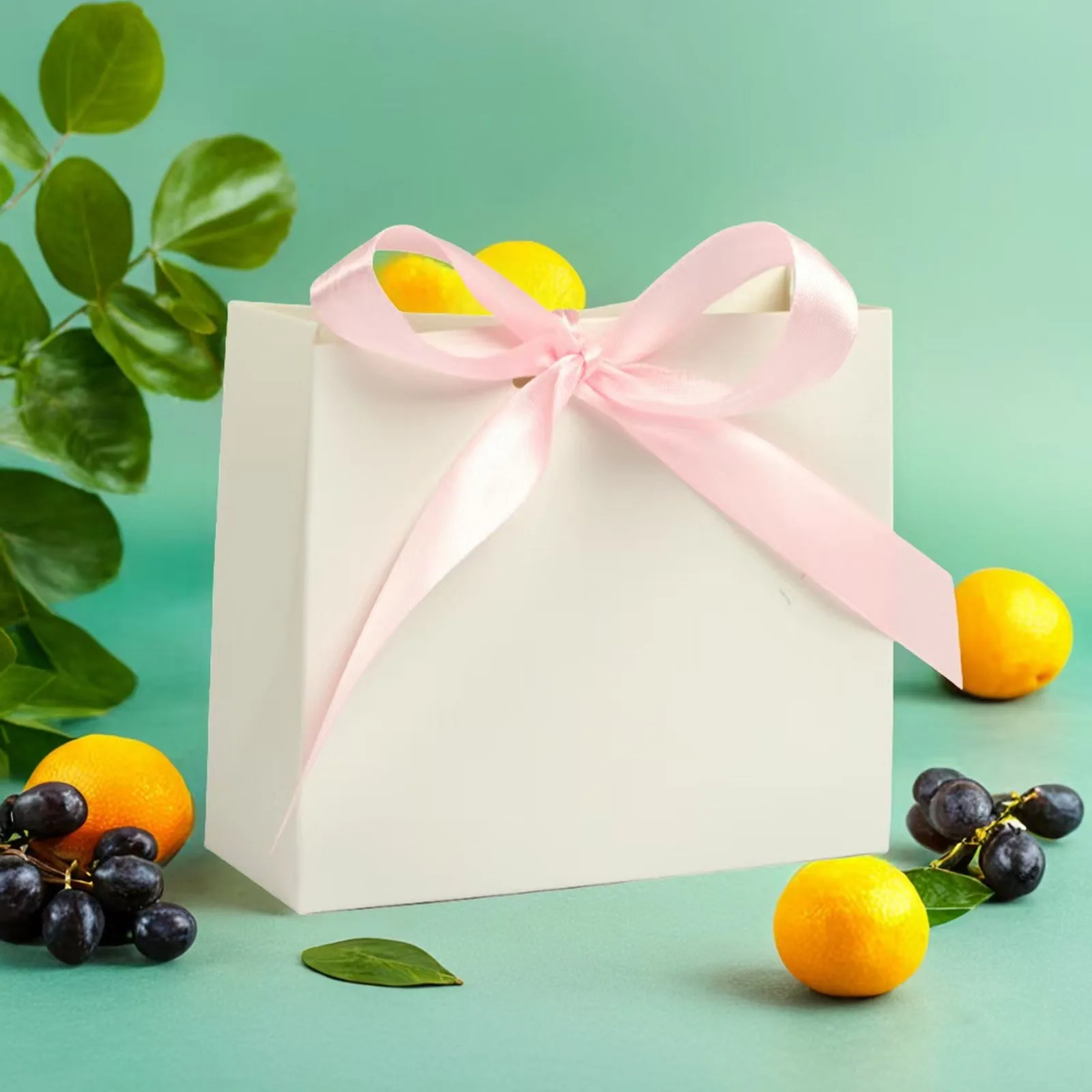 White mini gift bag tied with a pink satin bow