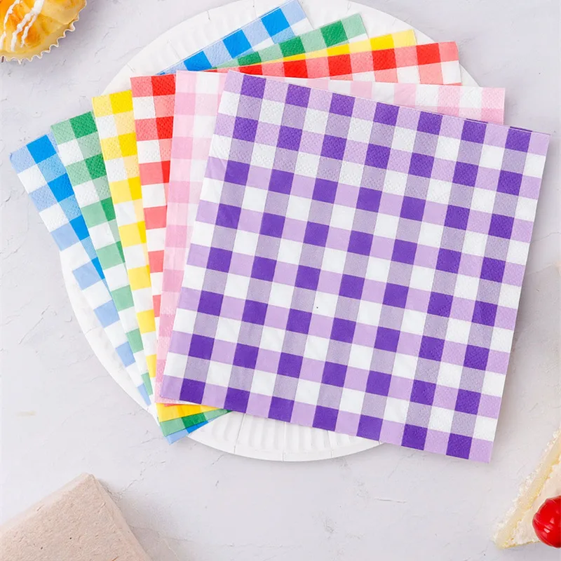 Gingham paper napkins fanned on a white plate