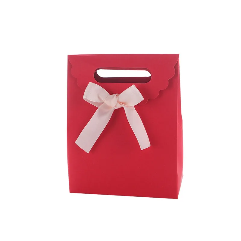 Red paper gift bag with pink satin bow