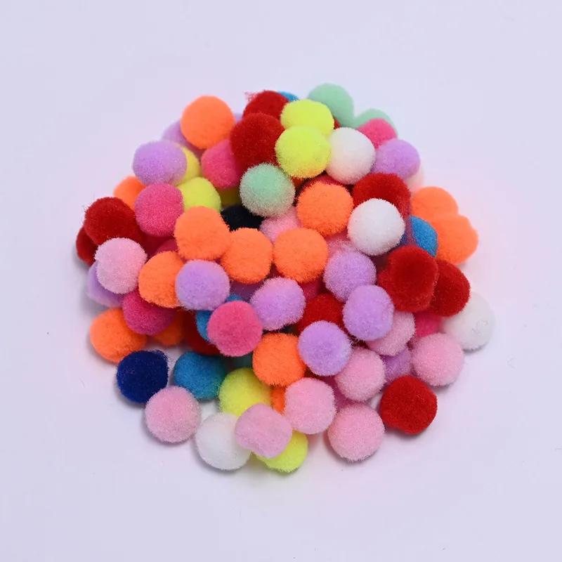 Mixed color mini pom poms on a lilac background