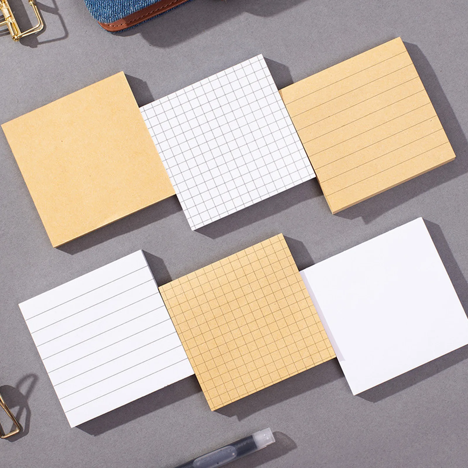 Kraft and white sticky note pads in lined, grid and blank styles