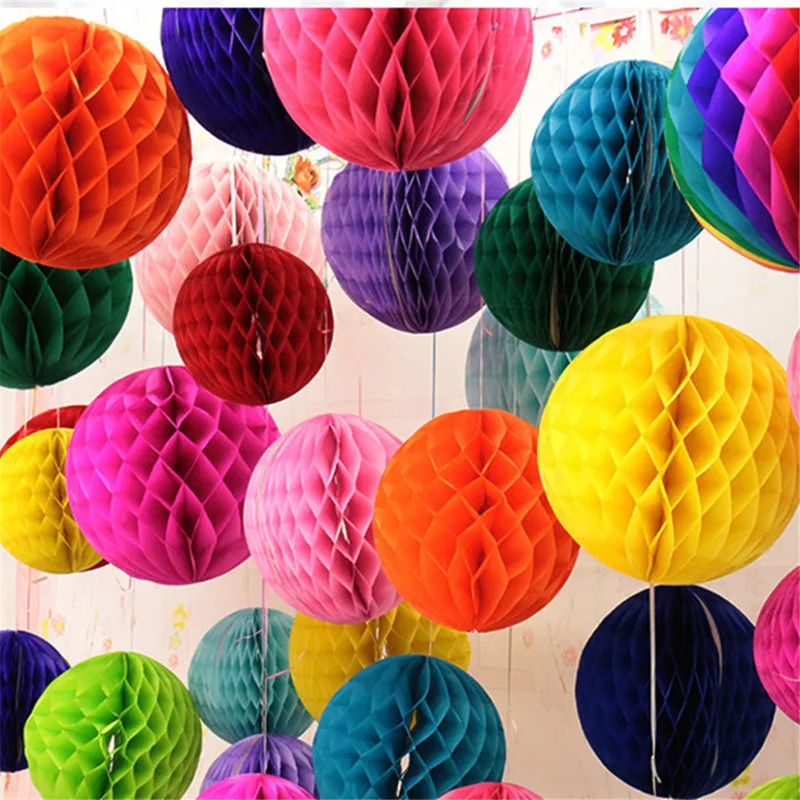 Many colorful honeycomb paper balls hanging from a ceiling
