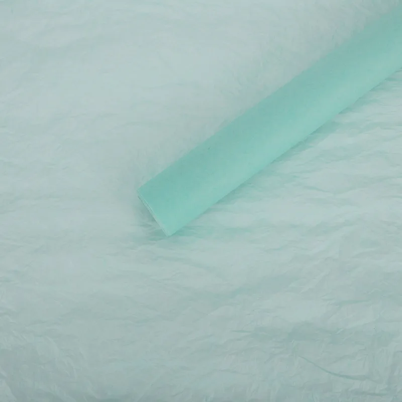 Mint tissue paper sheet with a rolled sheet on top