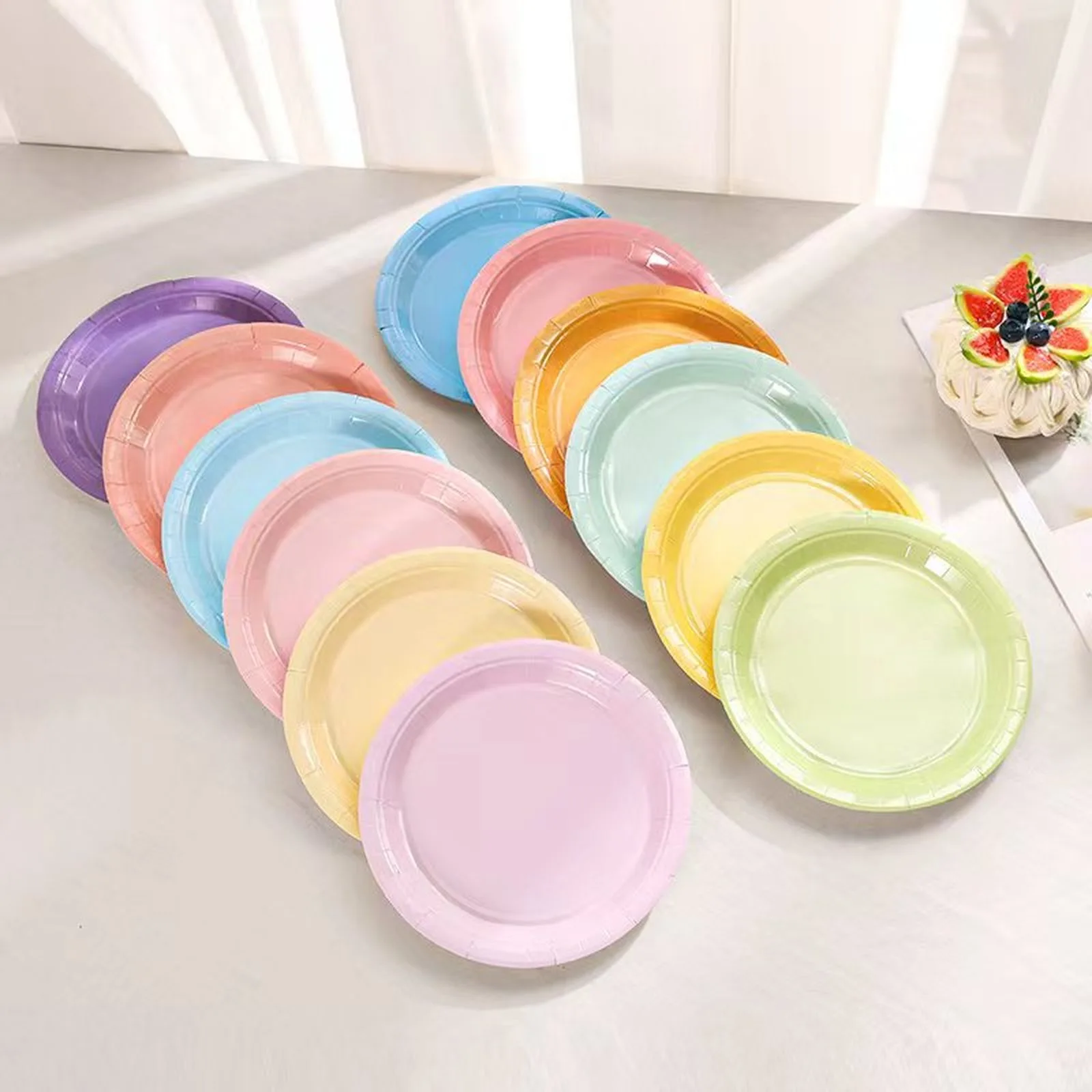 Pastel paper plates in twelve colors fanned out on a table