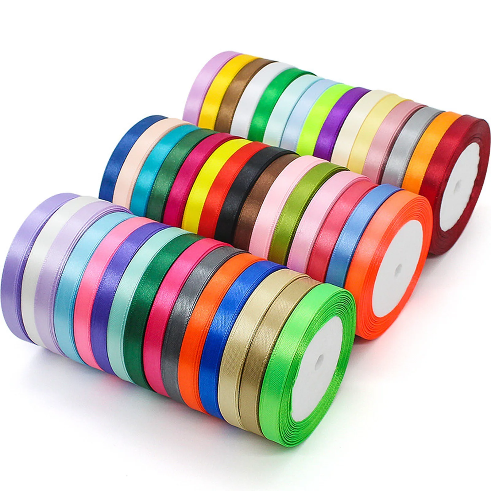 Three stacks of 3/8 inch satin ribbon rolls in many colors