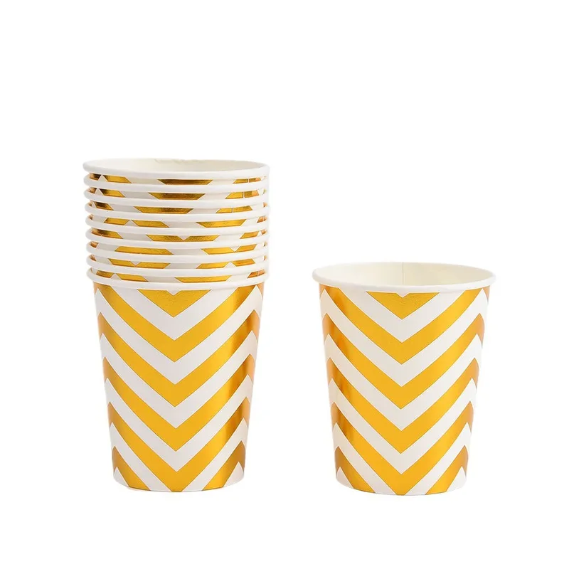 Stack of gold chevron paper cups beside a single cup