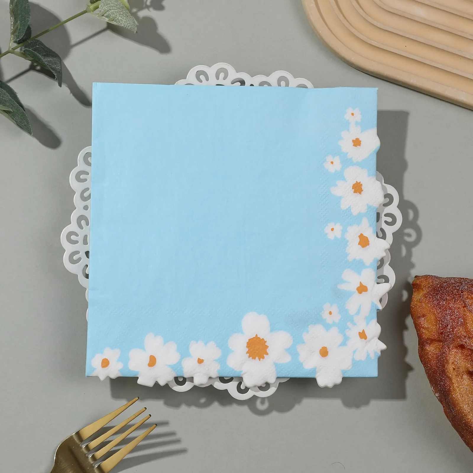 Sky blue daisy border napkin on a lace doily