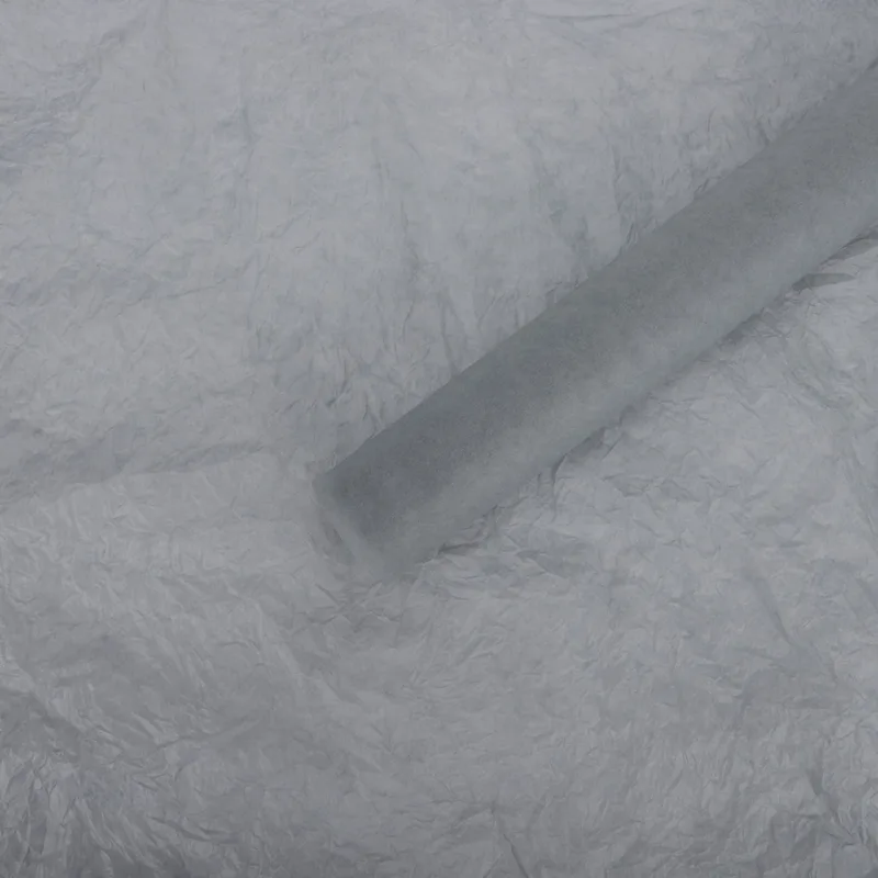 Gray tissue paper sheet with a rolled sheet on top