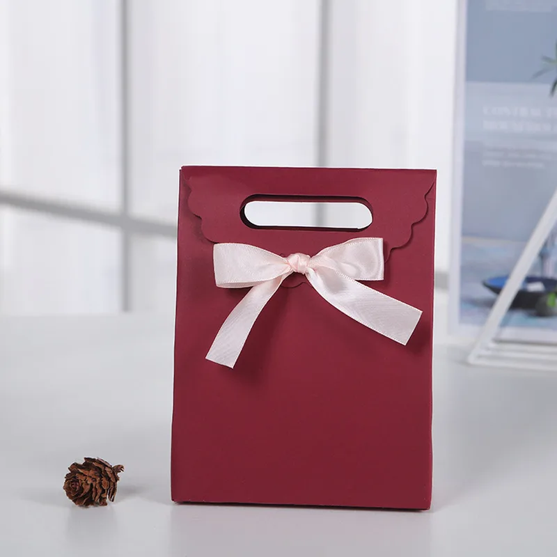 Burgundy paper gift bag with pink satin bow