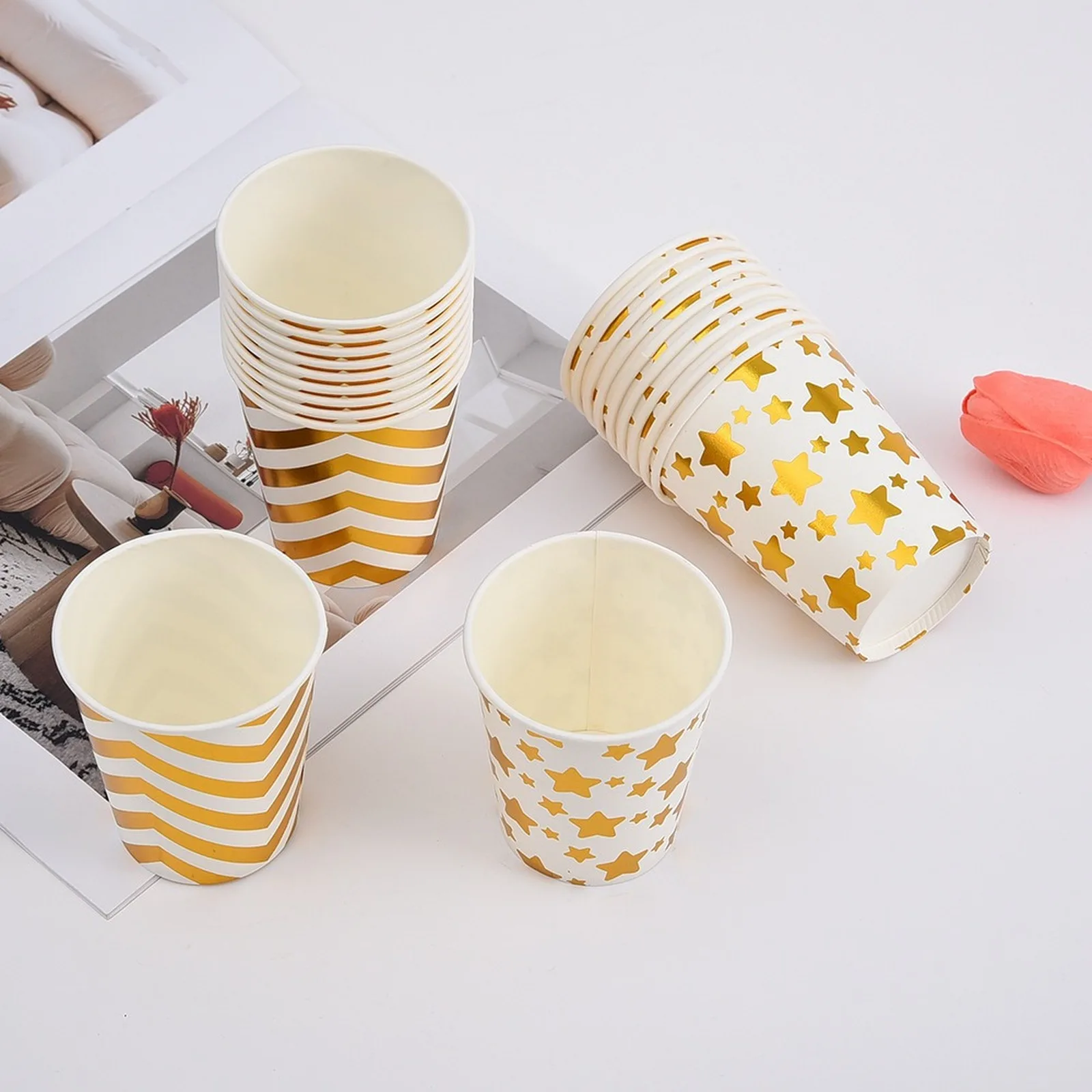 Gold chevron and gold star paper cups on a white table
