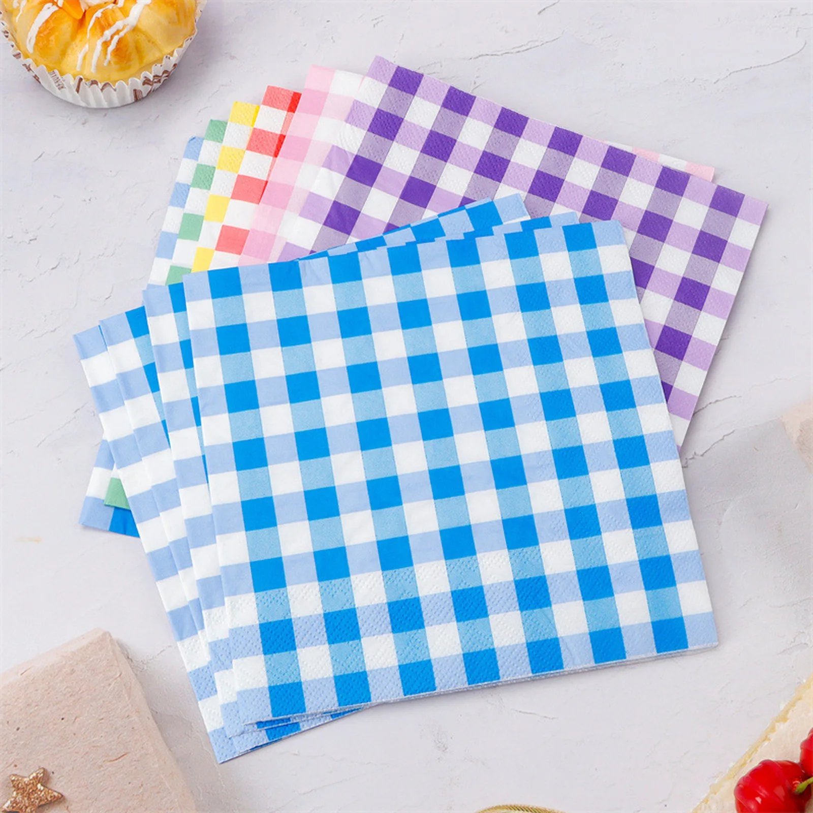 Gingham paper napkins in blue, purple and other colors on a table